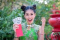 Action portrait beautiful Asian girl wearing Cheongsam red dress. Royalty Free Stock Photo