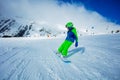 Action portrait of boy on snowboard ride downhill Royalty Free Stock Photo