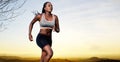 Action portrait of young african female athlete jogging at sunset