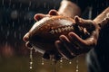 Action in the rain Football players hands grasp the wet ball