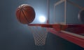 An action shot of a regular basketball teetering on the rim of a red basketball Royalty Free Stock Photo