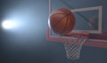 An action shot of a regular basketball teetering on the rim of a red basketball hoop Royalty Free Stock Photo