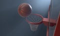 An action shot of a regular basketball teetering on the rim of a red basketball hoop