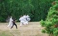 Action shot of students learning various Karate moves in a park in Germany