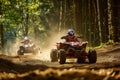 action shot of two atvs racing on a forest track Royalty Free Stock Photo