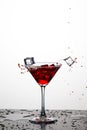 Action Splash Photography. Red Wine Glass With Splashes Against White Royalty Free Stock Photo