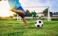 An action sport picture of a group of kids playing soccer football for exercise in community rural area Royalty Free Stock Photo