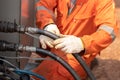 A worker hand is connecting and checking to high-pressure hydraulic hose line of power pack. Royalty Free Stock Photo