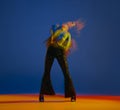 Action. Young girl dancing heels dance in stylish clothes over blue background in neon with mixed lights. Concept of Royalty Free Stock Photo