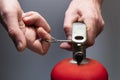 Actions in case of fire. Pull the safety pin out of the fire extinguisher by the ring. Men`s hands close-up. Safety measures in Royalty Free Stock Photo