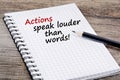 Actions speak louder than words! Text on notebook