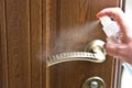 Actions to prevent the spread of COVID-19 coronavirus, door handle disinfection. Closeup of the hand wipes the door handle with a