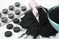 Activated black charcoal powder and pills and tablets in blister photo Royalty Free Stock Photo