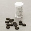 Activated Charcoal Tablets For Cleansing The Body On A Gray Background Closeup