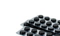 Activated charcoal tablets pills in blister pack on white background with copy space for text.