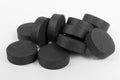 Activated charcoal tablets on white, natural absorbent Royalty Free Stock Photo