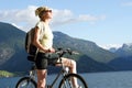 active 30ties woman on the bike in the mountains