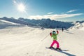 Active adorable preschooler caucasian kid girl portrait with ski in helmet, goggles and bright suit enjoy winter sport activities