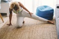 Active adult woman at home doing stretching workout exercises on the carpet for healthy lifestyle. Adult female people doing