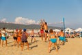 Active adults play the sport of volleyball on the sand beach