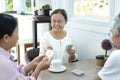 active asian senior pensioners enjoy free time with playing cards game together Royalty Free Stock Photo