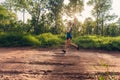 Active Asian woman running in the morning tropical forest trail Royalty Free Stock Photo