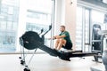 Active athlete man doing rowing workout