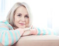 Active beautiful middle-aged woman smiling friendly and looking into the camera at home. Woman's face close up. Royalty Free Stock Photo