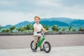 Active blond kid boy and bicycle near the sea. Toddler child dreaming and having fun on warm summer day. outdoors games for childr Royalty Free Stock Photo