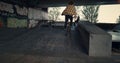 Active bmx rider performing tricks during freestyle session at skate park.