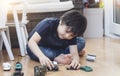 Active boy crawling on floor playing with soldiers and tank toys in playroom, Happy Kid playing wars and peace on his own, Child