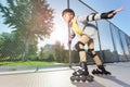 Active boy in helmet rollerblading at skate park