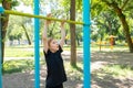 Active boy in the park Approached the crossbar and grabbed it, getting ready to do pull-up exercises Royalty Free Stock Photo