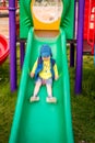 Active boy at playground, sliding down Royalty Free Stock Photo