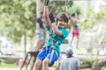 Active brave boy enjoying outbound climbing at adventure park on