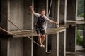 Active and brave young man balancing on a slackline