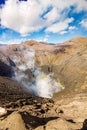 Active Bromo volcano mountain crater hole erupt with sulfur gas and smoke at Indonesia Bromo national park