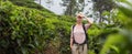 Active caucasian blonde woman enjoing fresh air and pristine nature while tracking among tea plantaitons near Ella, Sri