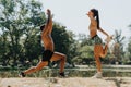 Active Caucasian couple jumping rope outdoors in a park. They have a fit body, positive results, and a healthy lifestyle