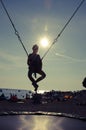 Active child in bungee jumping trampoline at sunset Royalty Free Stock Photo