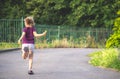 Active child - happy girl jumping with skipping rope outdoor in backyard Royalty Free Stock Photo