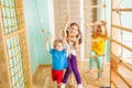 Active children excercising together at home training complex