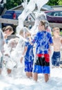 Active children play in bubbles and foam