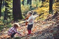 Active children play games on fresh air in autumn forest. Active rest and kids activity outdoor