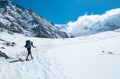 Active climber backpacker man with trekking poles and backpack climbing Mont Blank mount in French Alps mountains during high Royalty Free Stock Photo