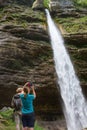 Active tourists looking at Pericnik waterfall in Vrata Valley in Triglav National Park in Julian Alps, Slovenia.