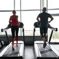Active couple exercising on treadmills in sports center Royalty Free Stock Photo