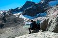 An active couple resting and enjoying the view on glacier lakes in the Hohe Tauern mountain chain in Carinthia, Austria