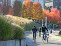 An active couple is riding on bicycles together on a street of the Vancouver. Street view travel photo