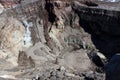 Active crater of Gorely volcano with a dried up, covered with ice lake and fuming fumarole, Kamchatka Peninsula Royalty Free Stock Photo